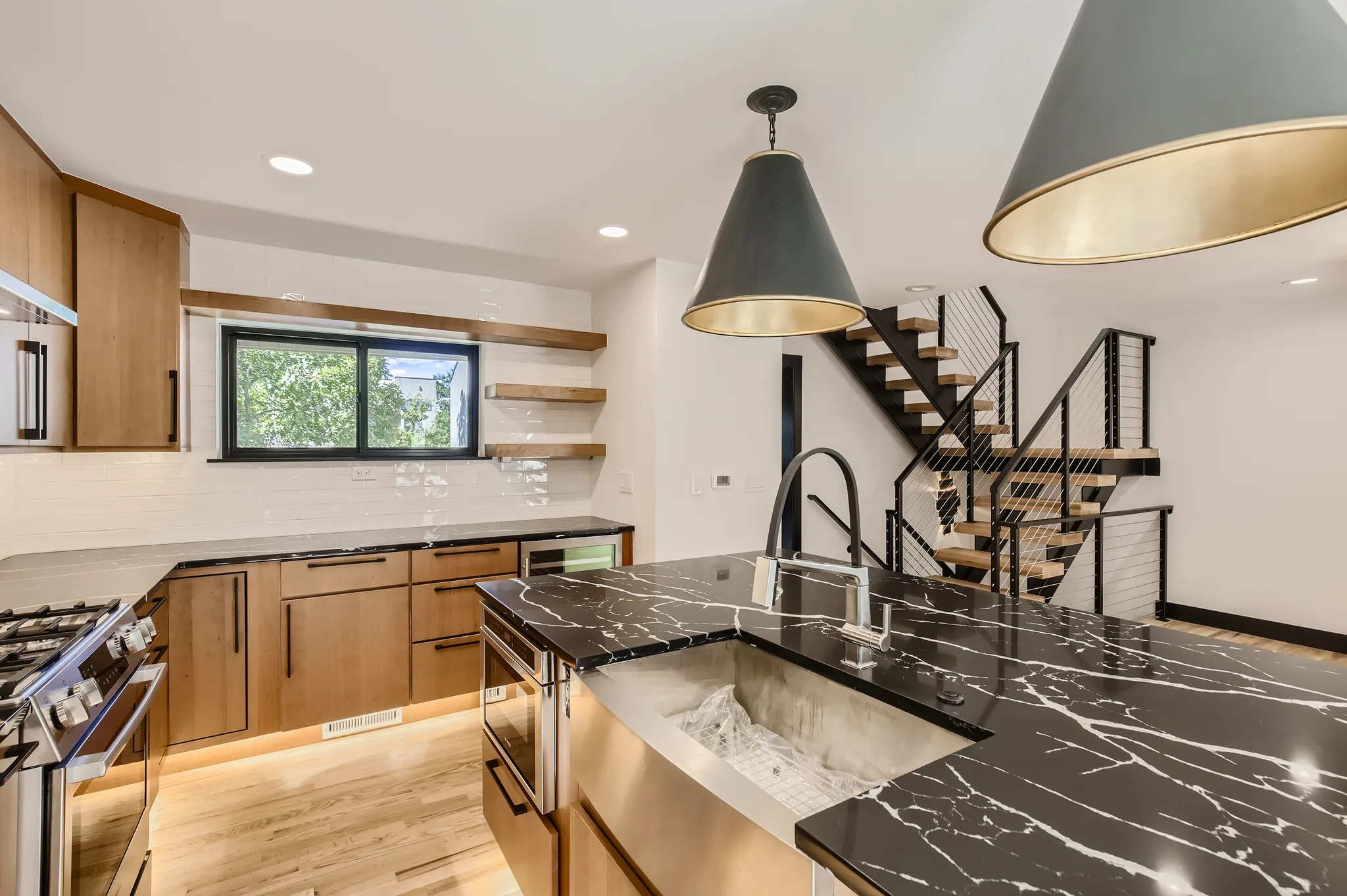 Completed kitchen remodel in Boulder by DG Home Pro showing custom cabinetry and stone counters